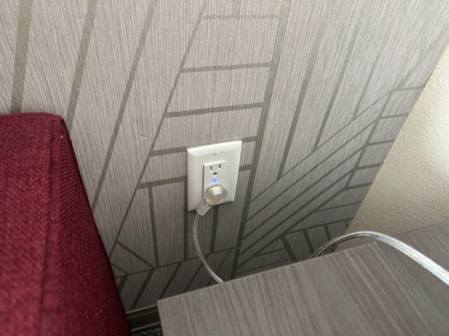 GridRabbit controlled outlet installed beside a hotel bed