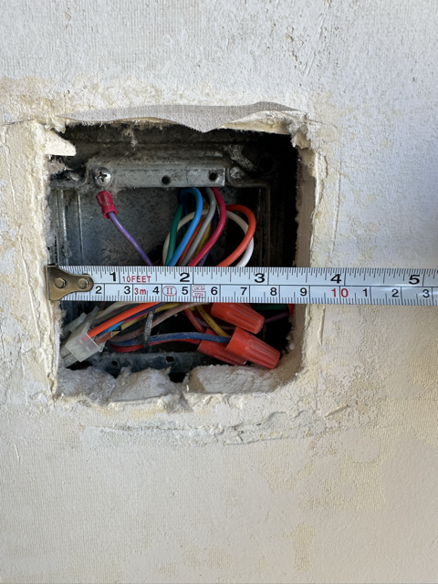 Renovation wall opening example showing what the thermostat beauty plate helps cover